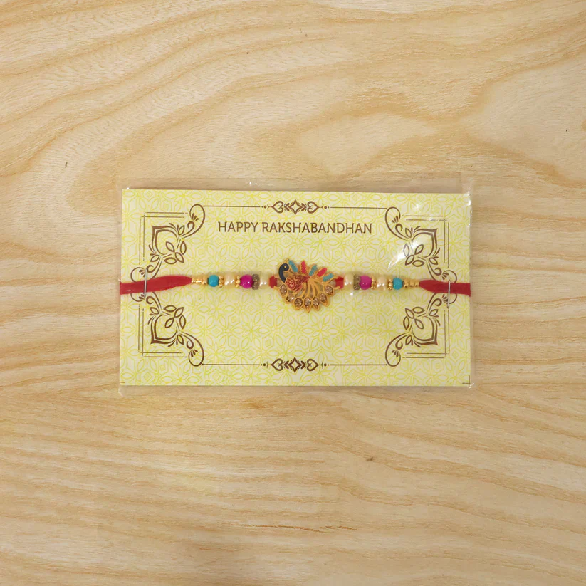 Peacock Rakhi – Elegant Stone Detailing with Red Thread - Image 7