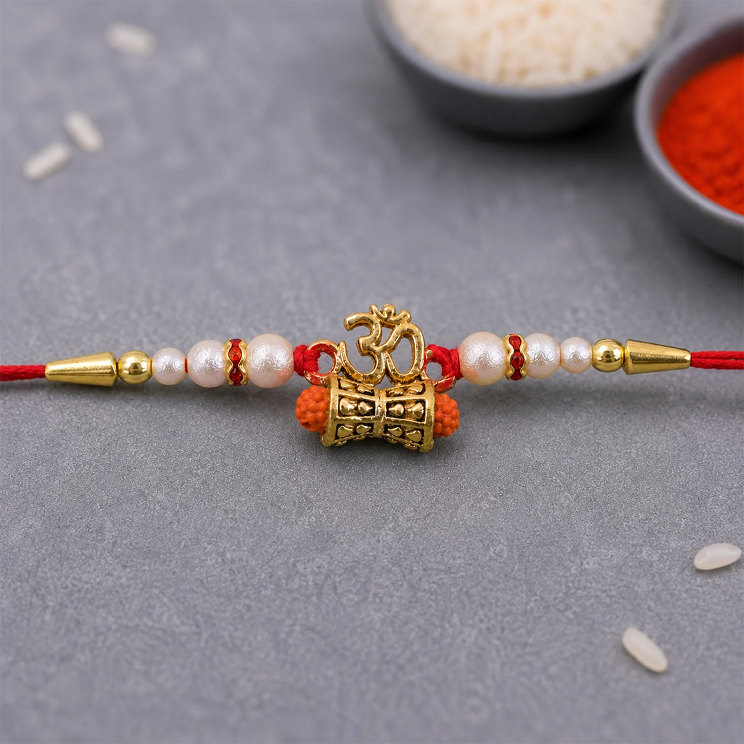 Golden Charm Rakhi – Pearl Beads, Red Thread for Brother - Image 3