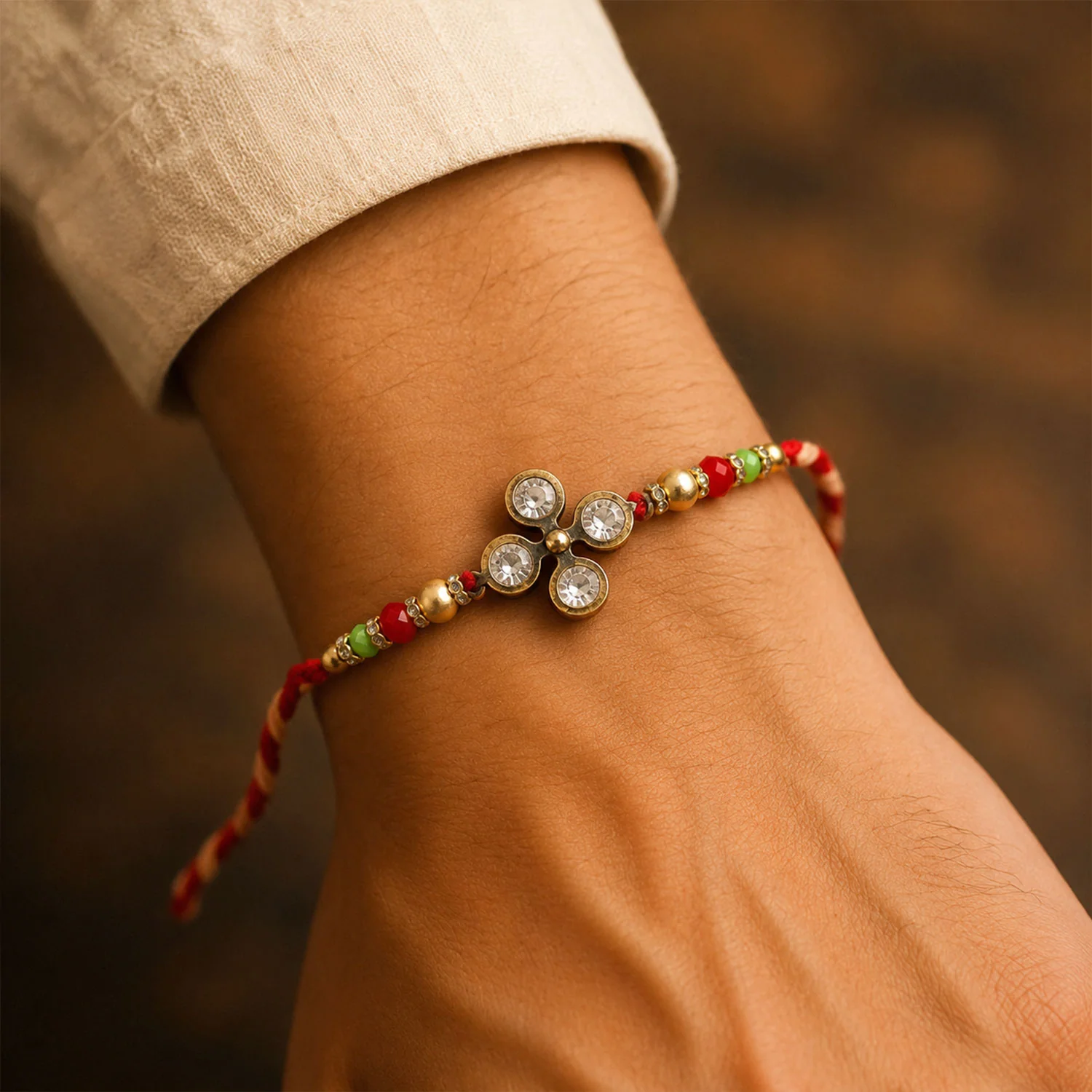 Four Crystal Clover Rakhi with Antique Gold Bezels, Red-Green Crystal & Golden Beads - Image 3