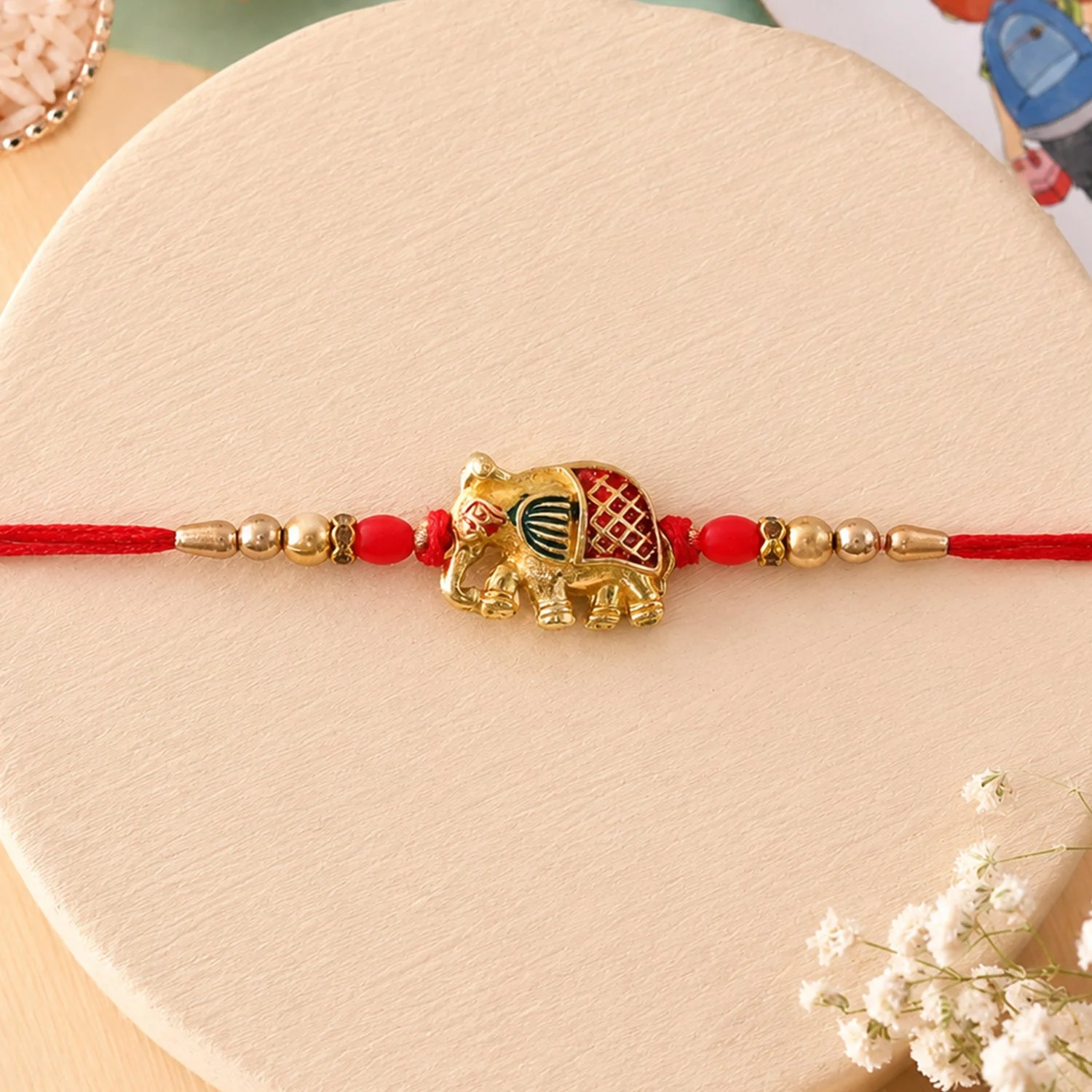 Rakhi – Stylish Gold Elephant Charm with Beads & Red Thread - Image 4