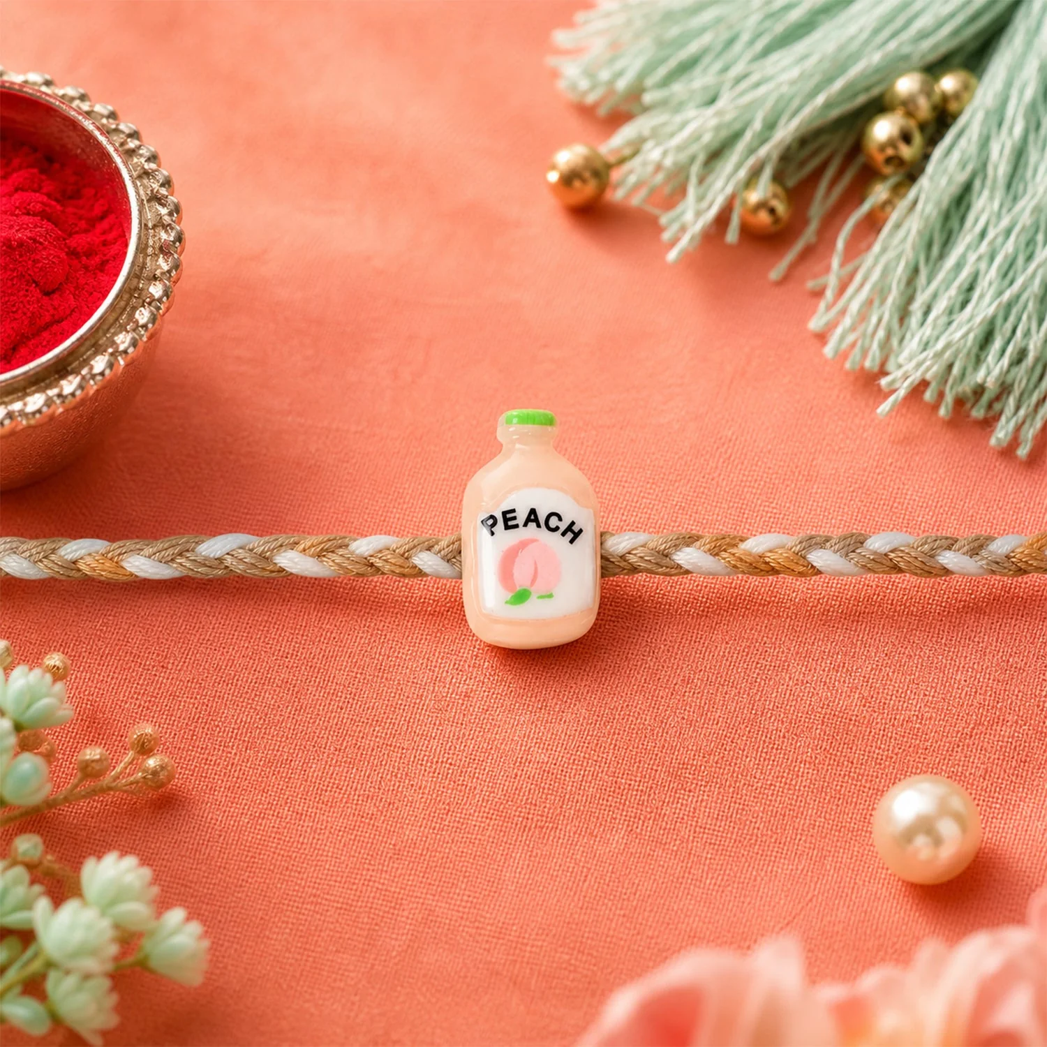 Peach Bottle Charm Rakhi – Elegant Festive Design for Brothers - Image 4