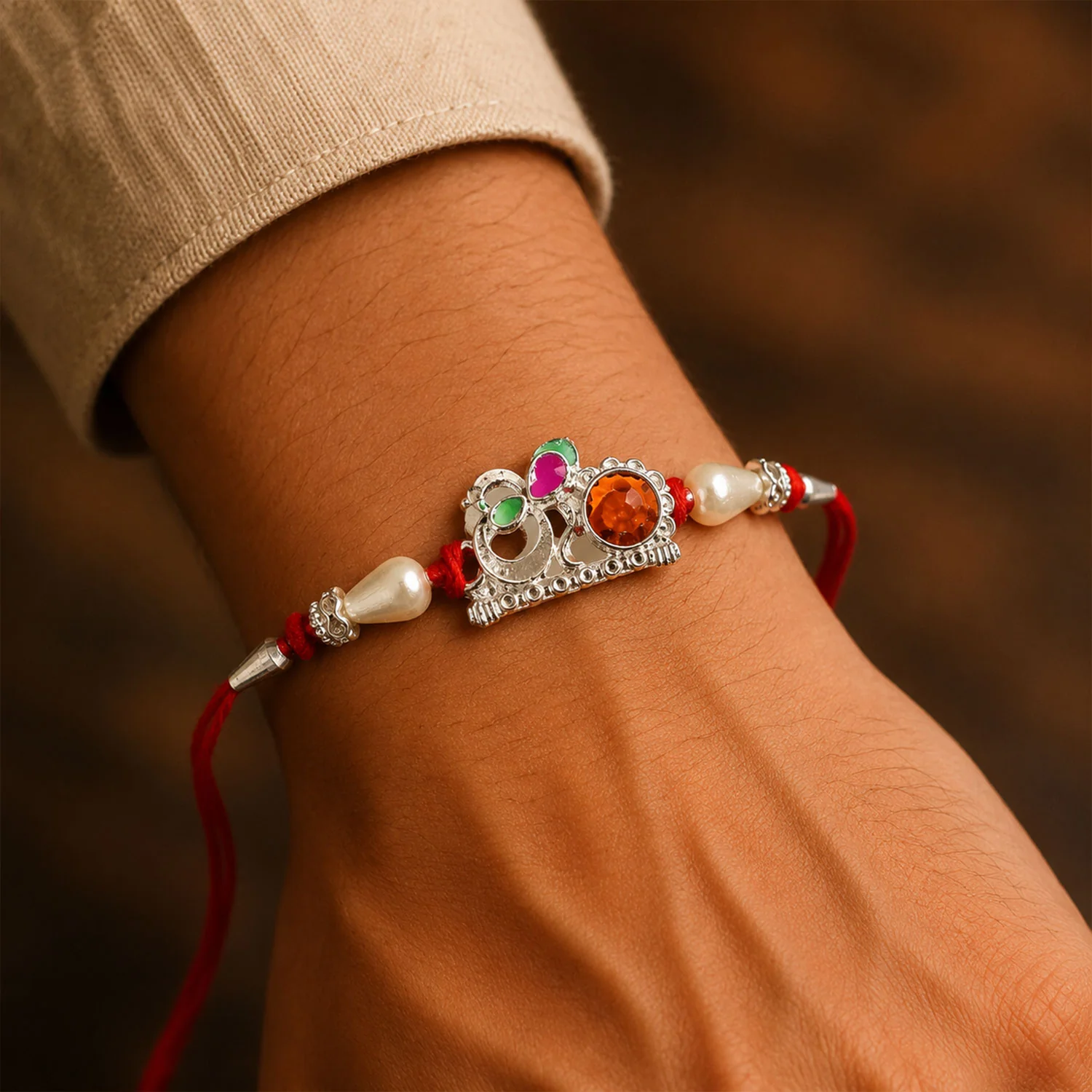 Rakhi – Elegant Red Gold Floral Om with Pearls & Stone - Image 3