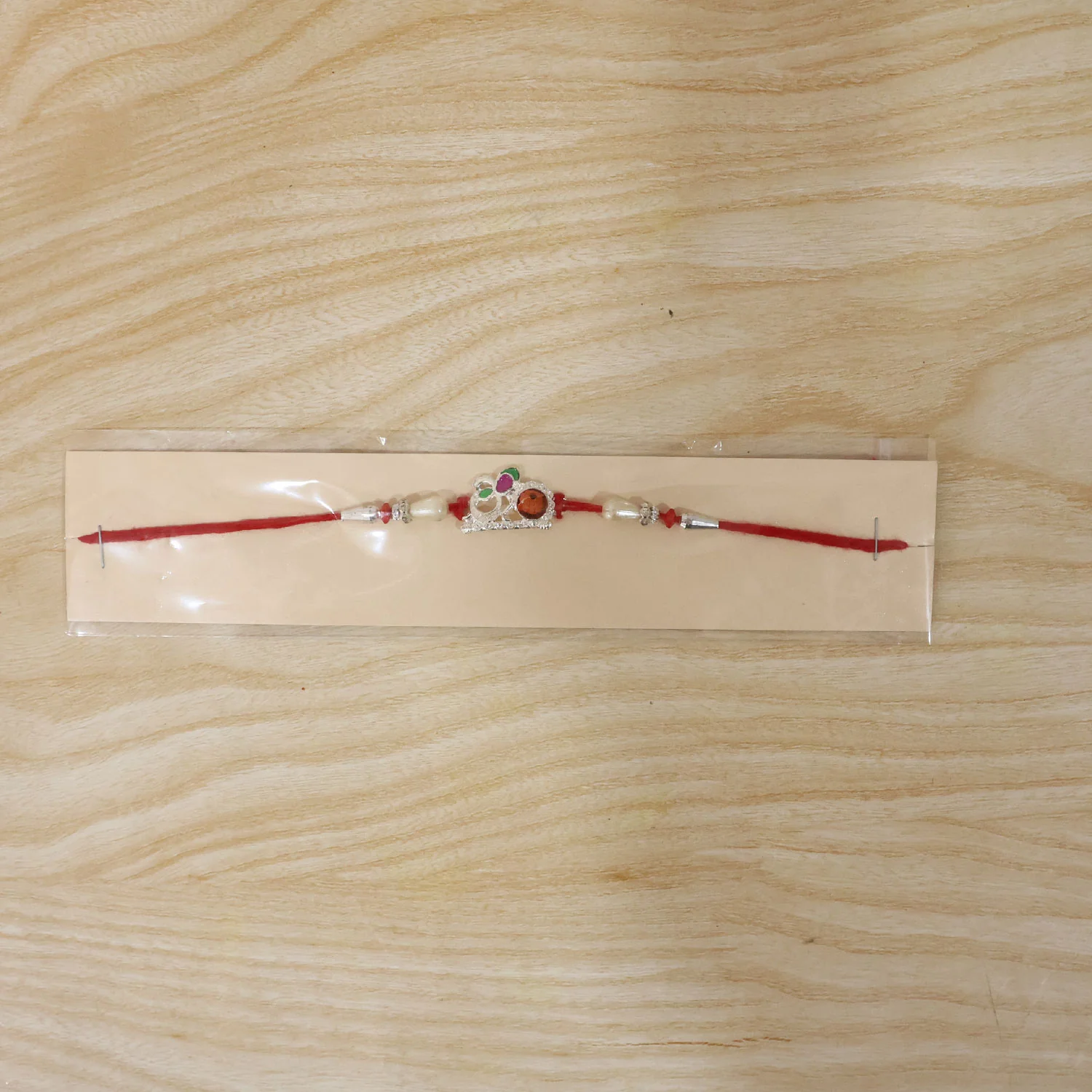 Rakhi – Elegant Red Gold Floral Om with Pearls & Stone - Image 6