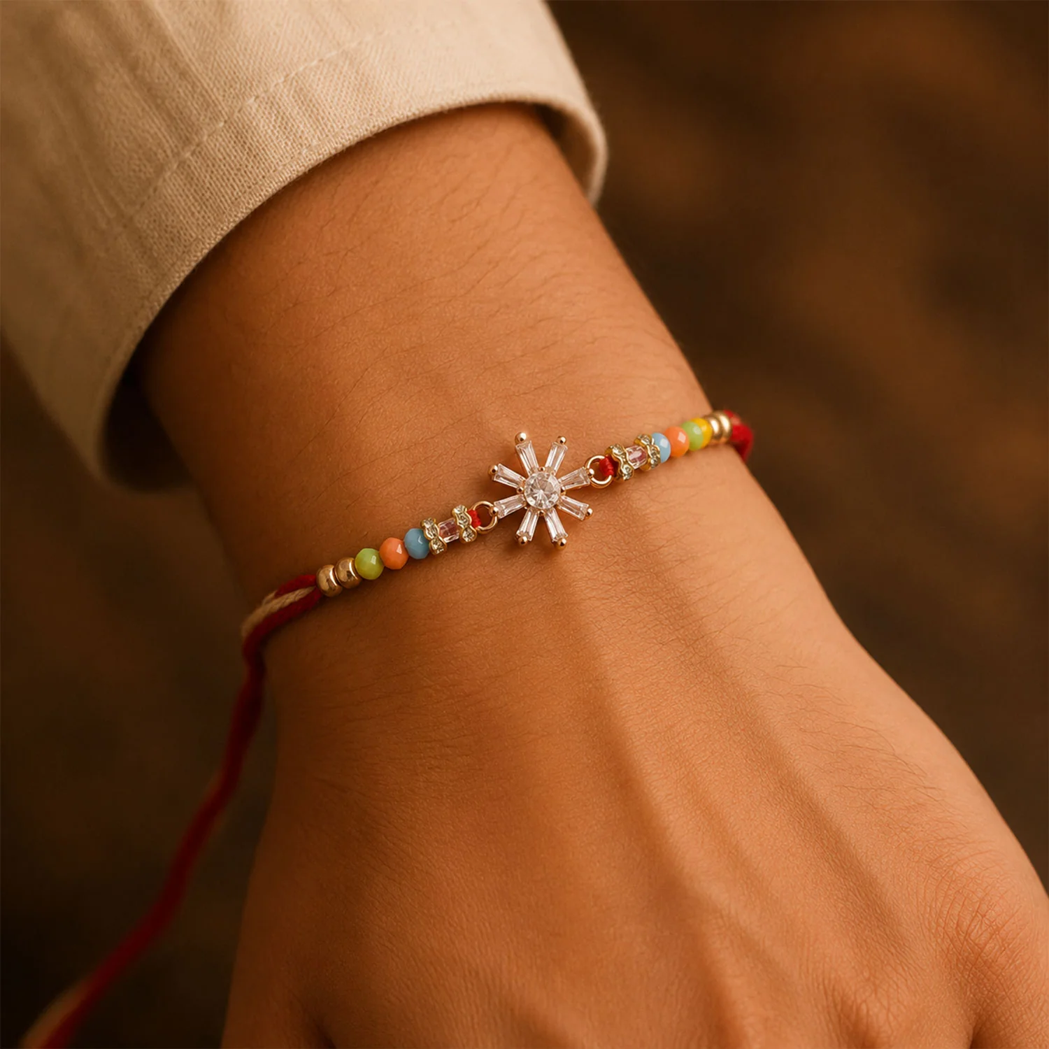Rose Gold Sunburst Crystal Rakhi with Baguette AD Stones and Rainbow Pastel Beads - Image 3