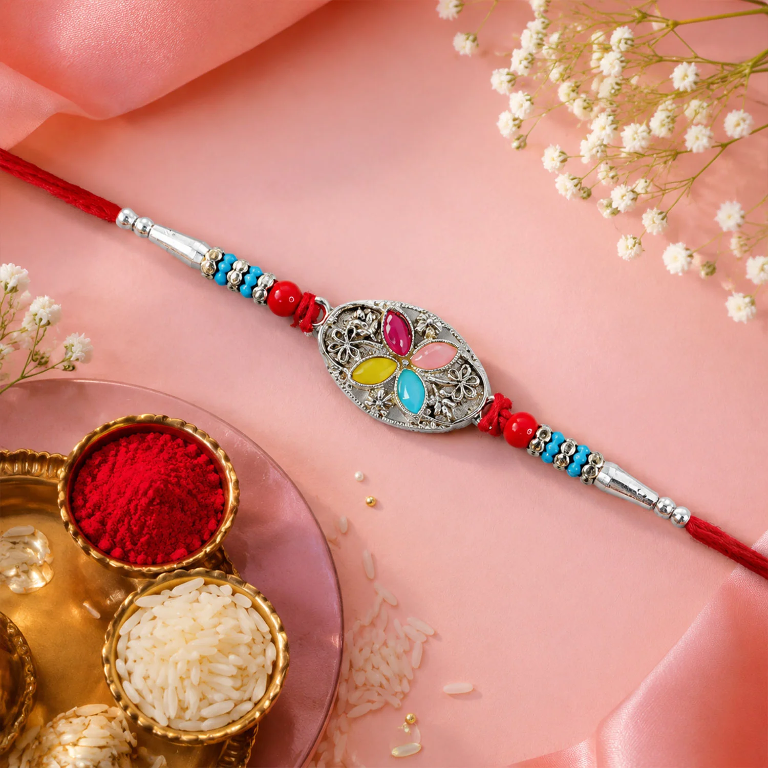 Silver Oval Floral Stone Rakhi with Color Petal Centre, Roli Chawal Coin and Card Packing - Image 3