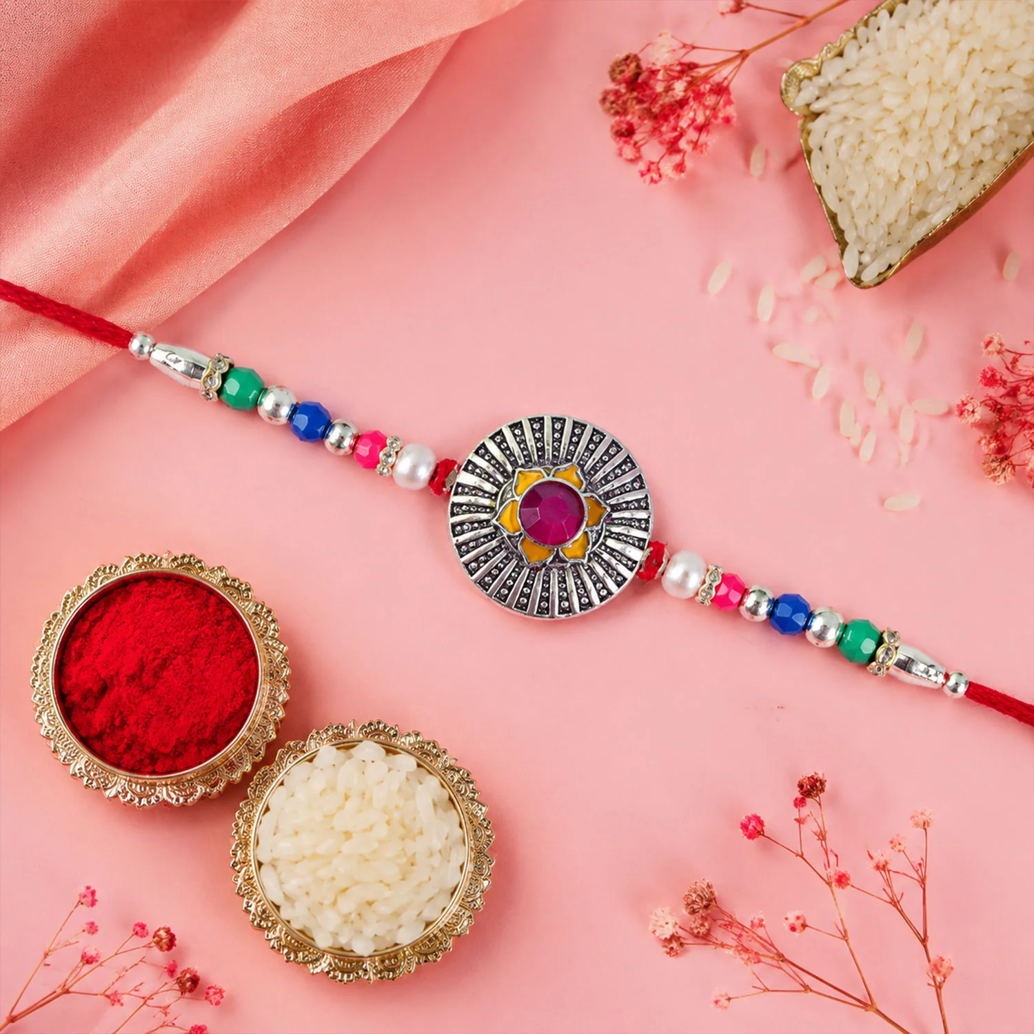 Sunburst Stone Rakhi with Magenta Centre, Pearl Beads, Roli Chawal Coin and Card Packing - Image 4